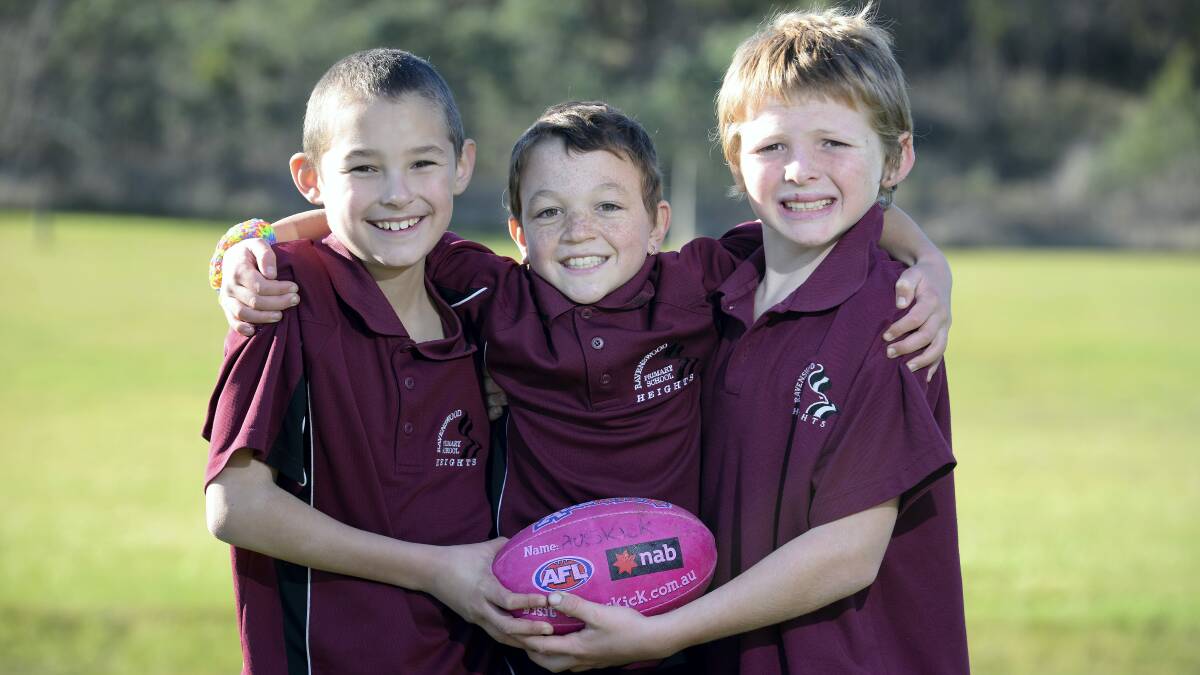Ravenswood Primary School pupils Peter Daines, Riley Lawson and Billy Thon, all 9, link up at the Auskick clinic. Picture: MARK JESSER