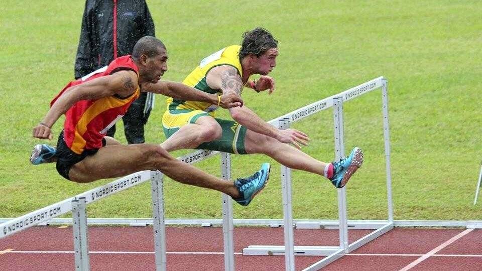  Western Suburbs runner Tyler Heron, in gold, on his way to winning silver  in the 110-metre hurdles at the Oceania Championships in Rarotonga.