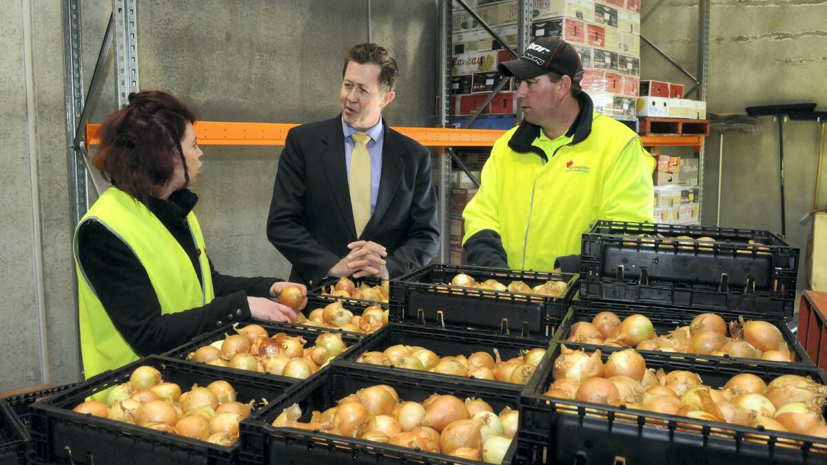 Stacey Binns and Jason Haberle, of Second Bite at Kings Meadows, talk to Assistant Employment Minister Luke Hartsuyker. Picture: PAUL SCAMBLER