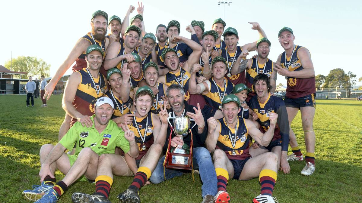 Old Scotch players celebrate their grand final victory yesterday. 