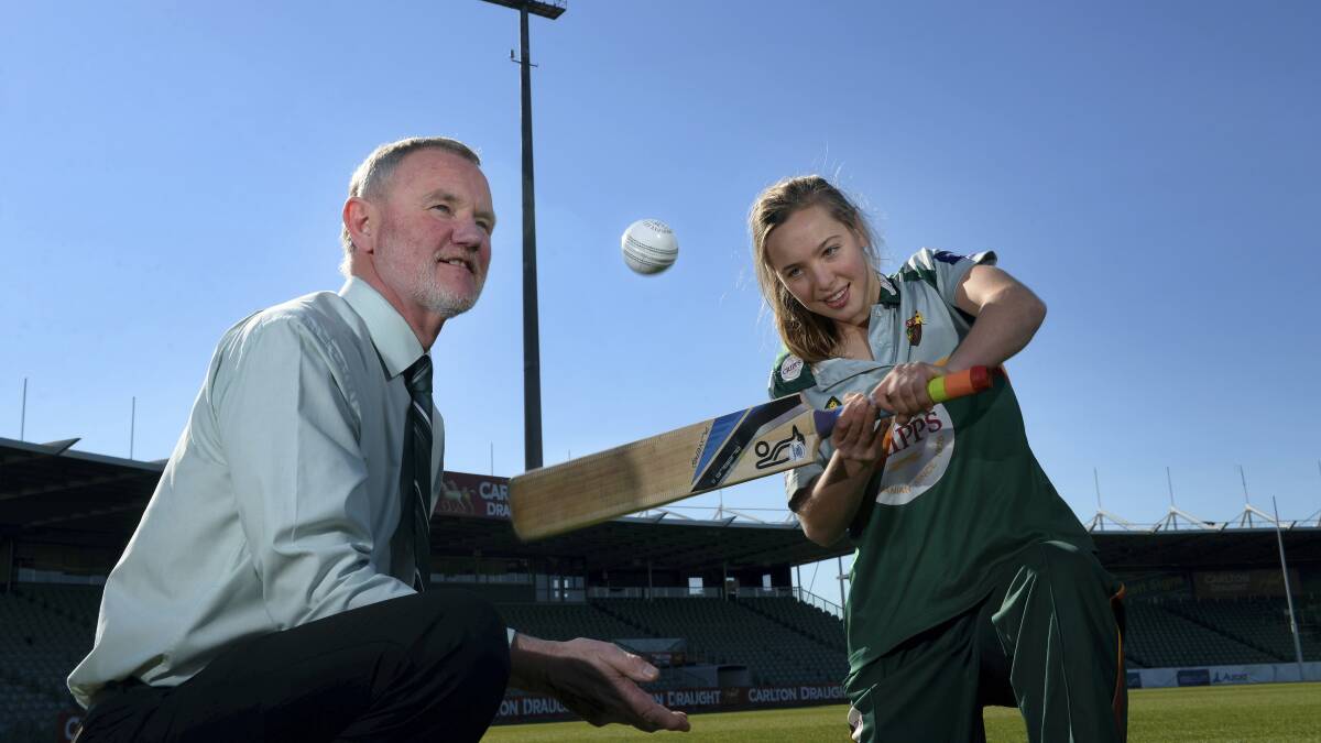 Launceston Mayor Albert van Zetten  gets some cricket tips from Tassie Roar’s Meg Phillips at Aurora Stadium yesterday.