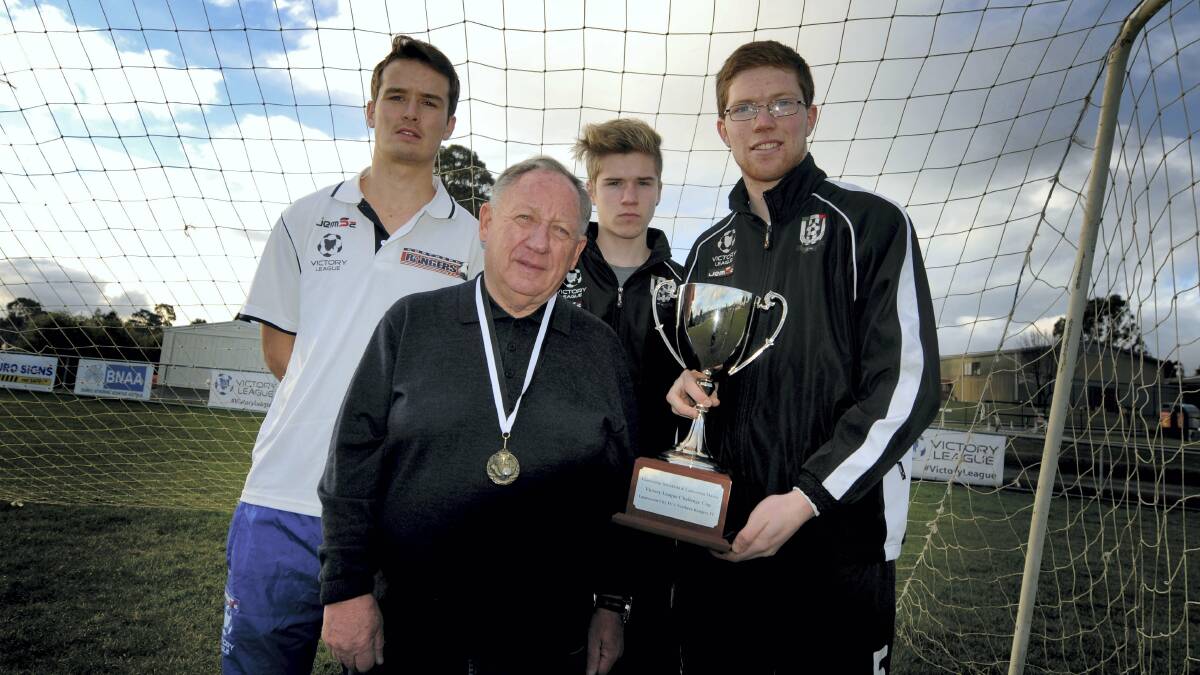 Launceston businessman John McKenna with soccer players Ryan McCarragher, of Northern Rangers, and Launceston City's Isaac Degetto and Daniel Egan with the  Challenge Cup. 