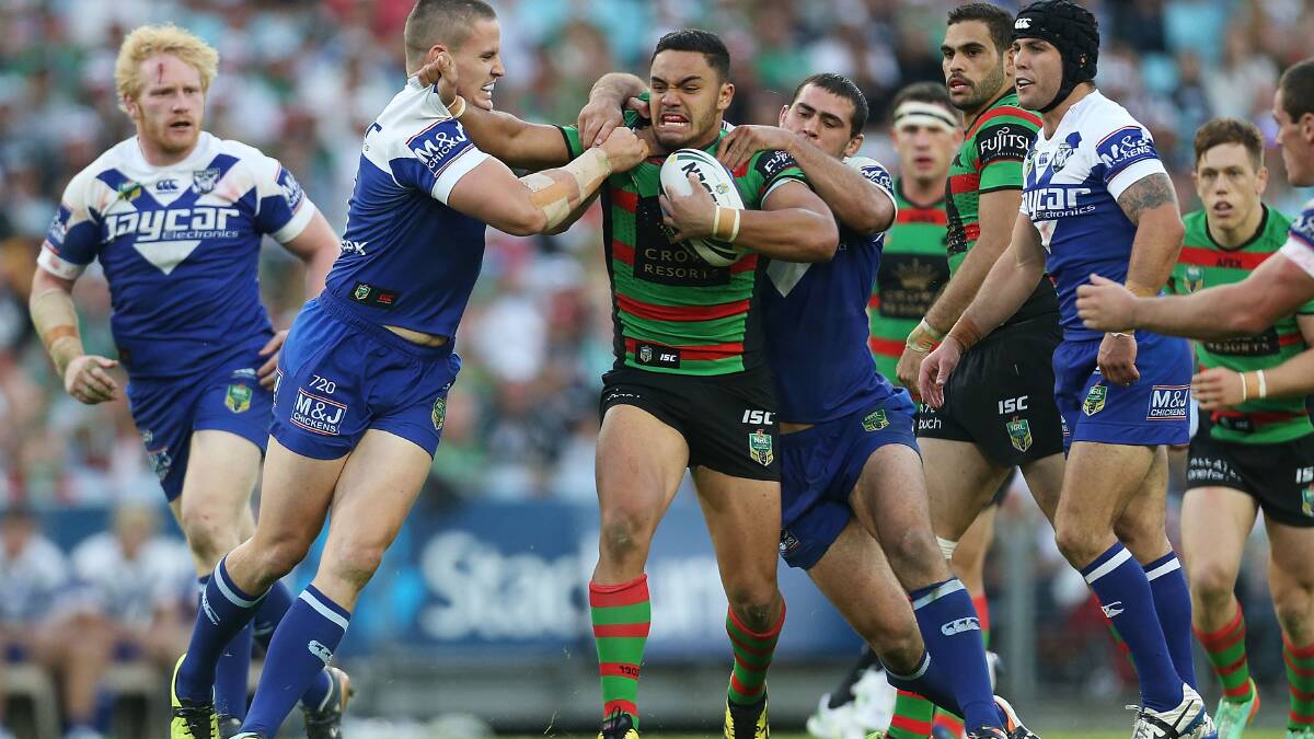 Dylan Walker of the Rabbitohs is tackled during the round seven NRL match between the South Sydney Rabbitohs and the Canterbury-Bankstown Bulldogs at ANZ Stadium on April 18, 2014 in Sydney, Australia. Photo: Mark Metcalfe/Getty Images.