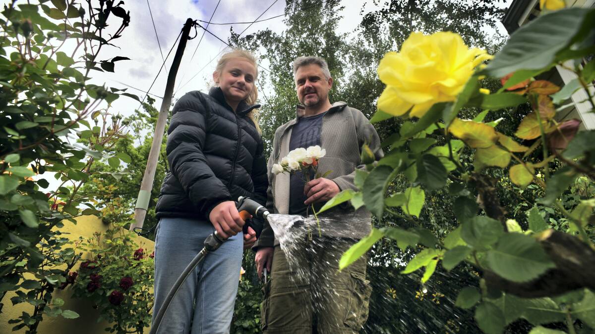 Erica, 11, and her dad Gene McLaren give their Invermay garden a much-needed watering after Northern Tasmania experienced one of the driest Octobers on record.  Picture: PAUL SCAMBLER
