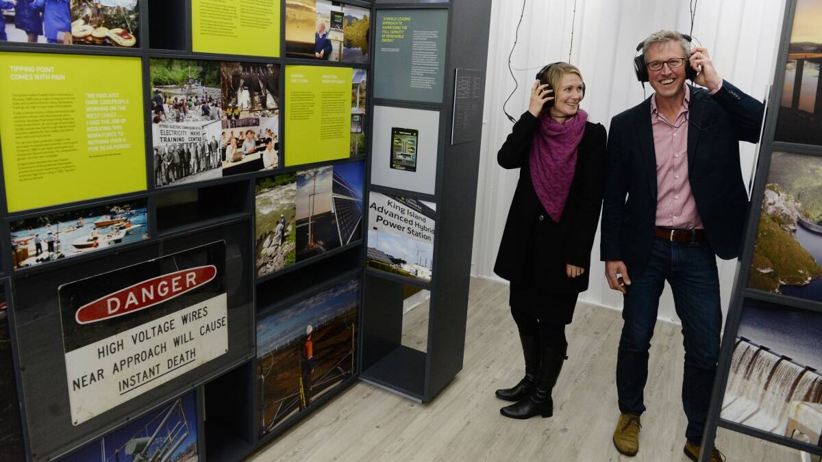 Hydro Tasmania's centenary program manager Lara van den Berg and Queen Victoria Museum and Art Gallery exhibition manager Andrew Johnson listen to the sounds of wind turbines at the 100 Years of Hydro pop-up exhibition.