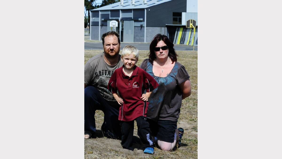 Rob and Mel Goymour with Brodie, 5, at Ravenswood Heights Primary School where cattle have been damaging the oval and playgrounds.  Picture: NEIL RICHARDSON