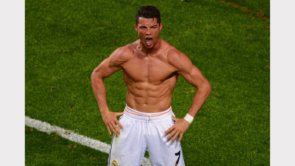 THOSE ABS: Real Madrid star Cristiano Ronaldo celebrates scoring their fourth goal from the penalty spot during the UEFA Champions League Final between Real Madrid and Atletico de Madrid at Estadio da Luz on Sunday in Lisbon, Portugal. Photo: Getty Images