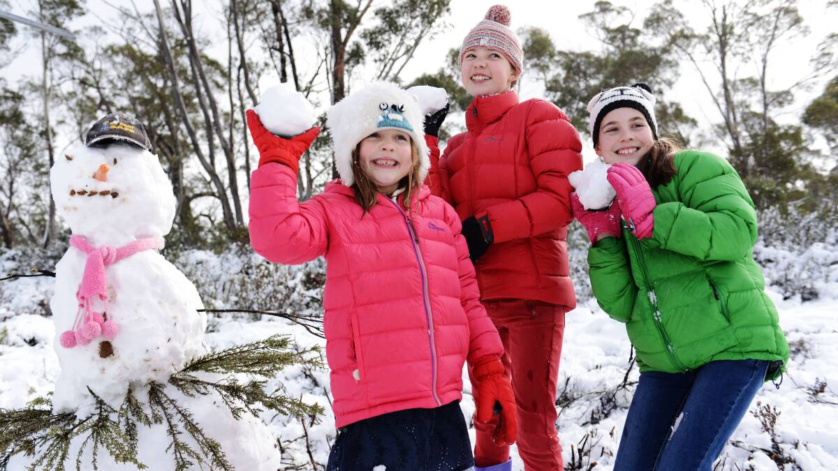 Eliza, 6, Millie,11, and Imogen Duigan 10, all of Launceston, enjoy some snow on the Central Highlands. Picture: SCOTT GELSTON.