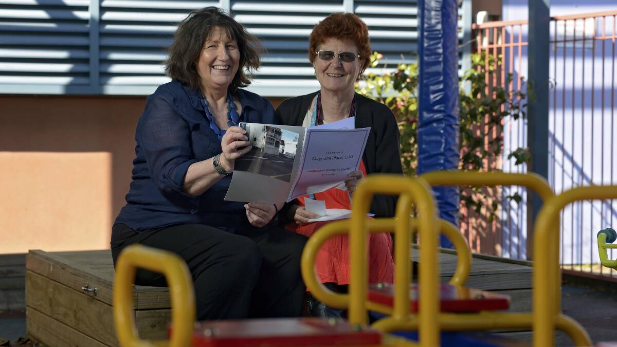 Magnolia Place historian Marilyn Barnewall and chief executive Jenny (surname withheld) with some literature on the history of the women’s shelter. Picture: PHILLIP BIGGS