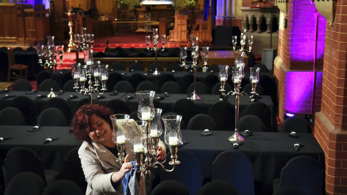 St Giles profile and engagement manager Danielle Blewett puts a final shine on the candlesticks in readiness for the Black Diamond Dinner. Picture: SCOTT GELSTON