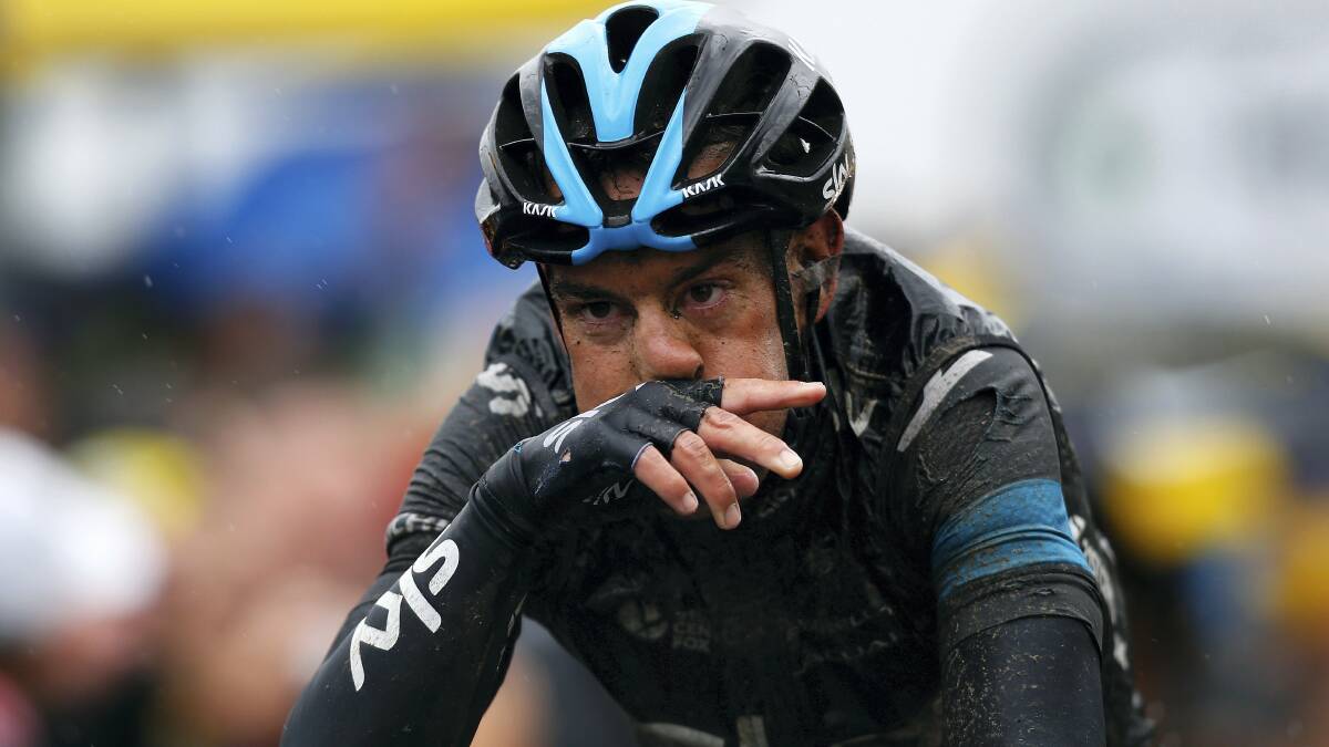 A wet, tired and mud-splattered Richie Porte crosses the line to finish yesterday's crash-hit stage.  Picture: GETTY IMAGES
