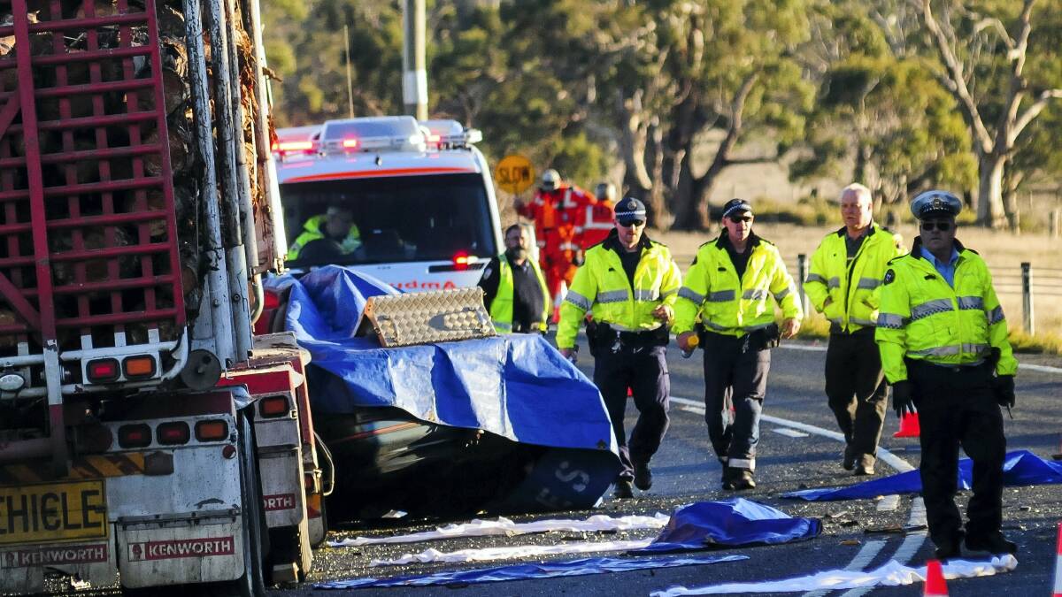 The scene of the crash involving a sedan and a log truck yesterday on the Midland Highway near Ross. Two people were killed.   Picture: PHILLIP BIGGS