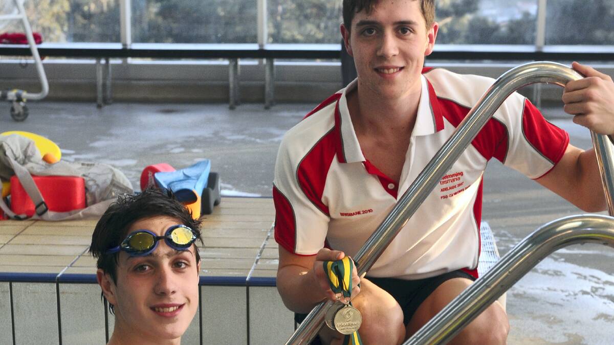  Brothers James Curran, 13,  in the pool, and Tom Curran, 18, back from the Schools Sports Australia National Swimming  Championships.  Picture: PAUL SCAMBLER