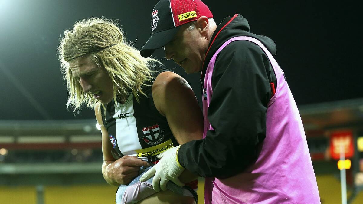 St Kilda recruit Eli Templeton is helped from the ground with a broken arm in the match against Brisbane Lions in Wellington. Picture: GETTY IMAGES