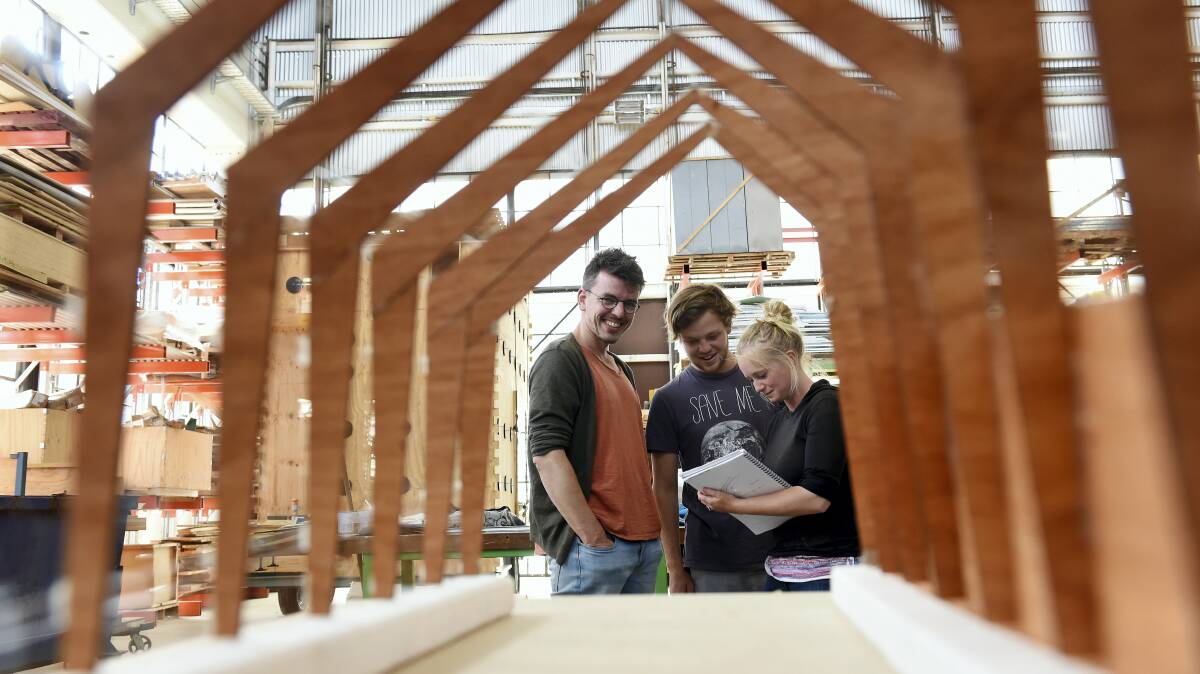 Jiri Loew, Hugh Jones and Cara Massey assess their greenhouse model, which they will build at the University of Tasmania design school this week.  Picture: MARK JESSER