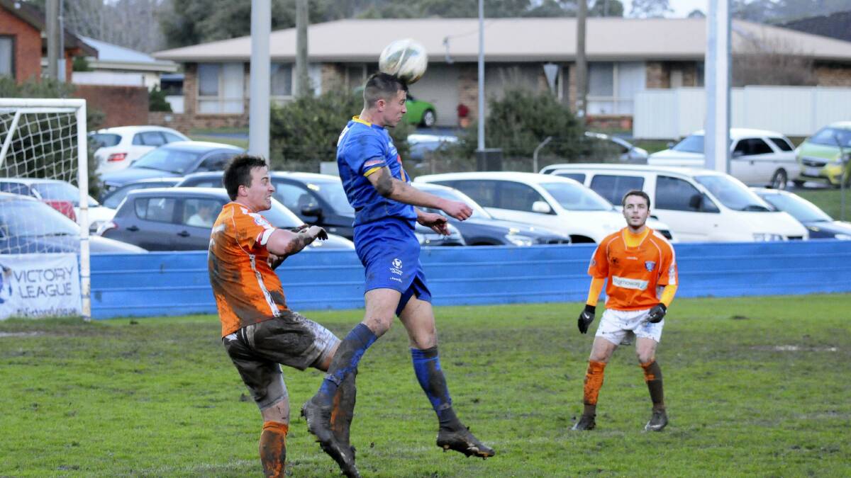 Devonport's Callum Moore and South Hobart's Hugh Ludford in action at Valley Road yesterday.  Picture: PAUL SCAMBLER