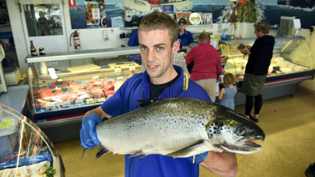 Kyeema Seafoods general manager Zac Langford with an Atlantic salmon, one of the popular items on the Easter menu.  Picture: PAUL SCAMBLER