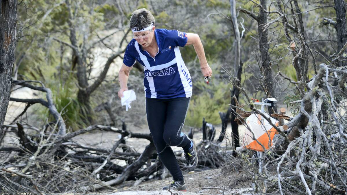 Jenny Bourne, of Victoria, competes in the Tasmanian orienteering championships at St Helens.