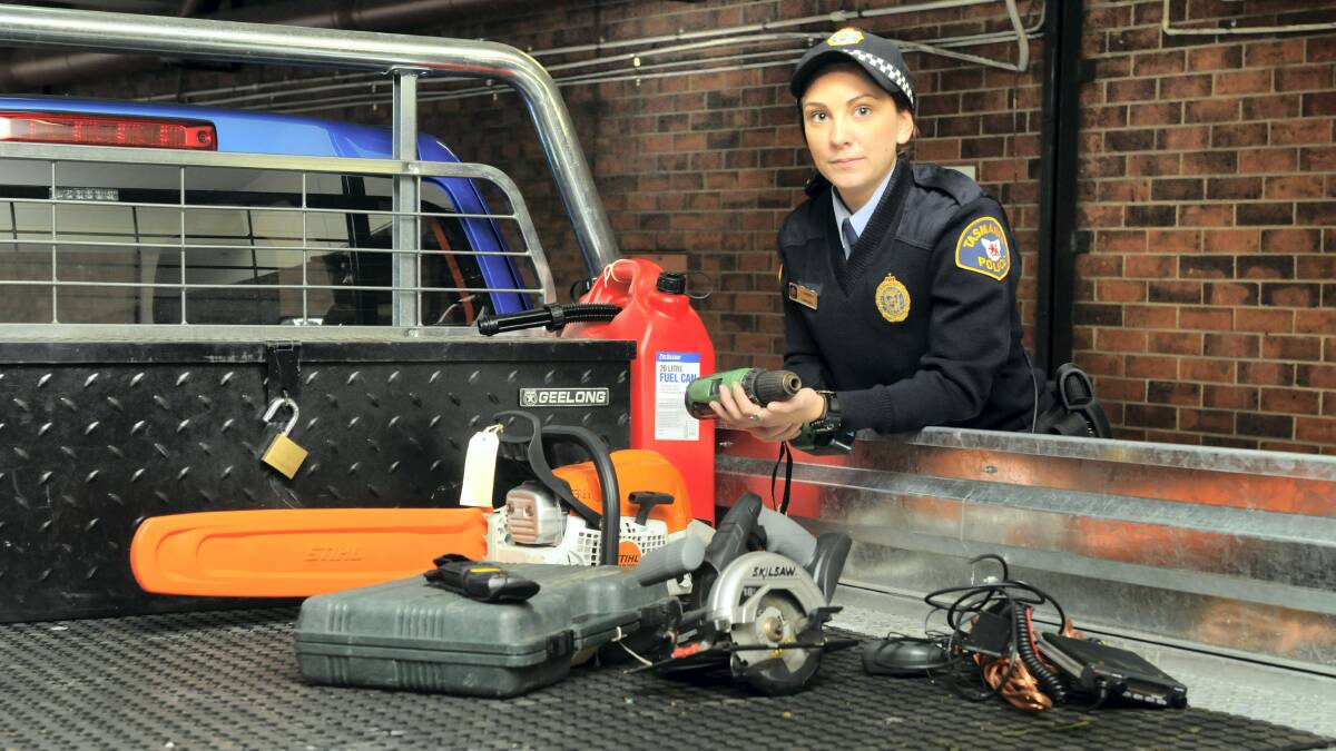 Constable Lucy Barwick with some of the popular items to be stolen from tradies' utes and vans. Picture: PAUL SCAMBLER