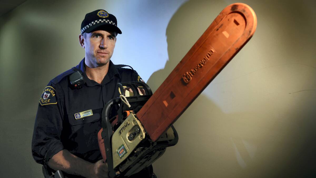 Constable Daniel Richardson holds a recovered chainsaw from lost property - a hot item for thieves in and around Launceston. Picture: SCOTT GELSTON