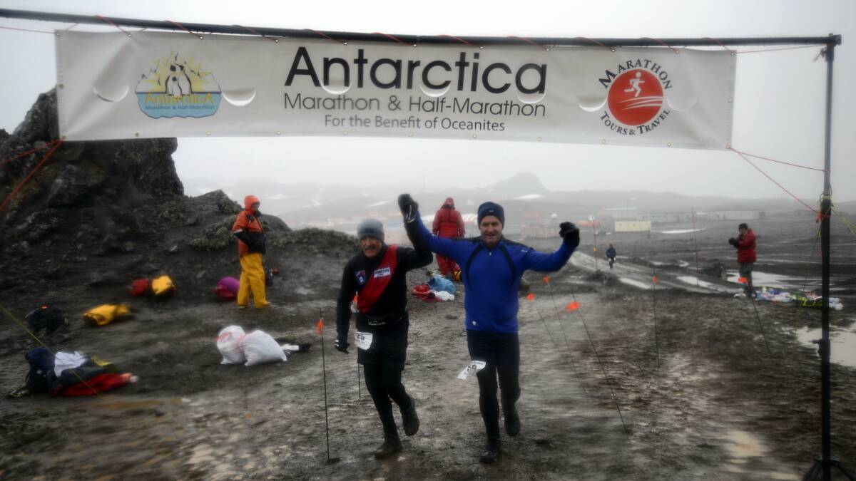 Over the line . . . Michael Booth and David MacFarlane cross the finish line of the Antarctic marathon.