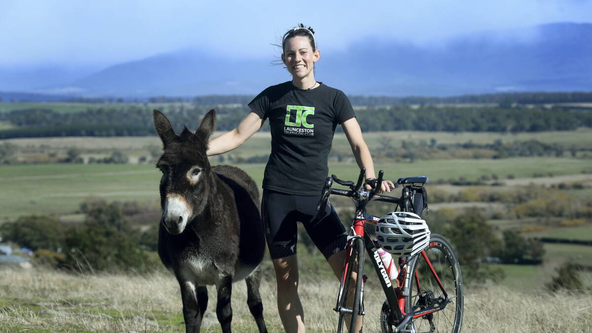 Mini the donkey with Launceston triathlete Melissa Clark, who is seeking sponsorship for next month's Port Macquarie Ironman competition to raise funds for the Big Ears Sanctuary at Longford. Picture: MARK JESSER