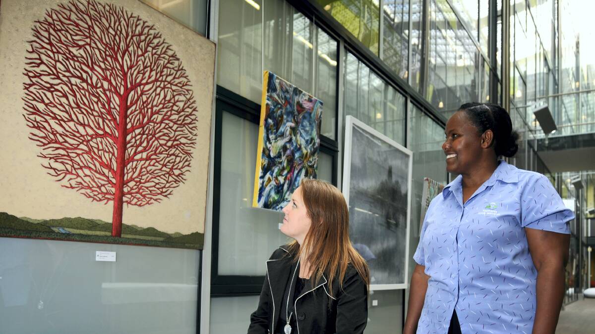 Bethan Frake and Alemi Halango admire the LGH Art Prize winning work, The Tree of Life/Arterial Tree.  Picture: GEOFF ROBSON
