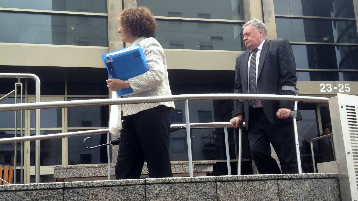Tim Ellis leaves the Hobart Magistrates Court yesterday with his wife, Anita Smith.