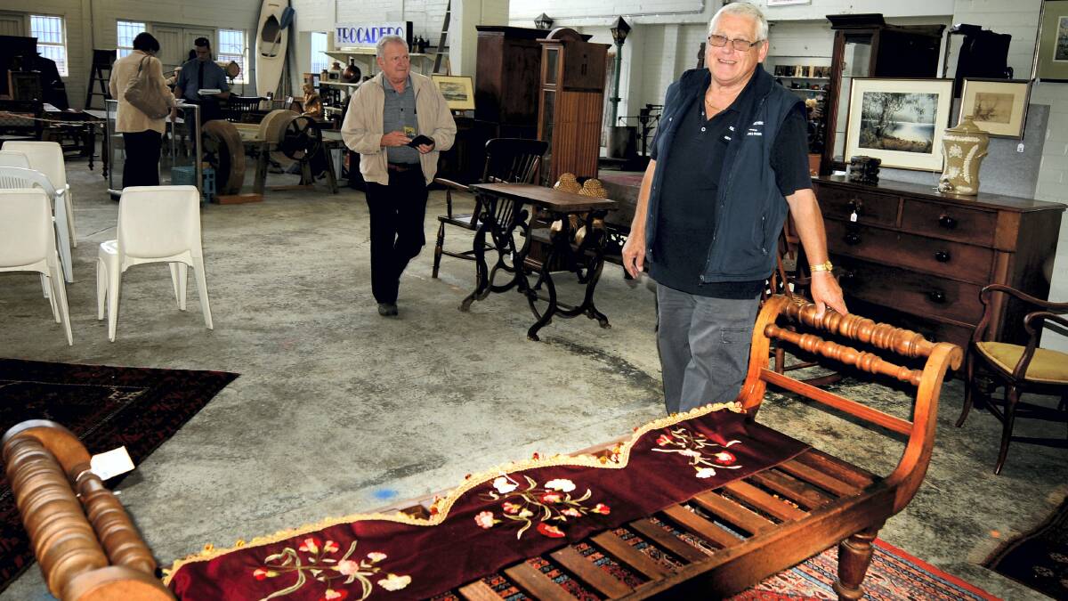 Geoff Lidgerwood, of Tullochs Auctions, with the 1830s cedar settle valued at about $10,000. Picture: GEOFF ROBSON