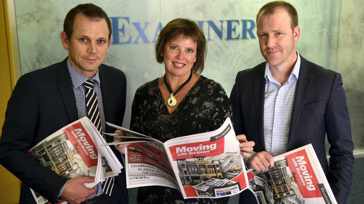 The Examiner commercial media manager Dan Ryan, journalist Mary Machen and advertising features manager Daniel Richardson with a copy of Moving with the times: Our history your stories.  Picture: PAUL SCAMBLER