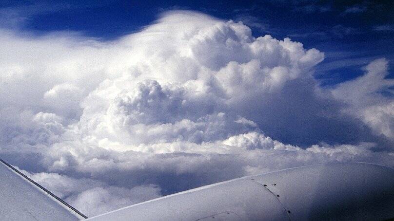 Large cumulus clouds over the Midlands in spring 2001 ... the largest of these clouds are already showing signs of glaciation on the left. Picture: HYDRO TASMANIA