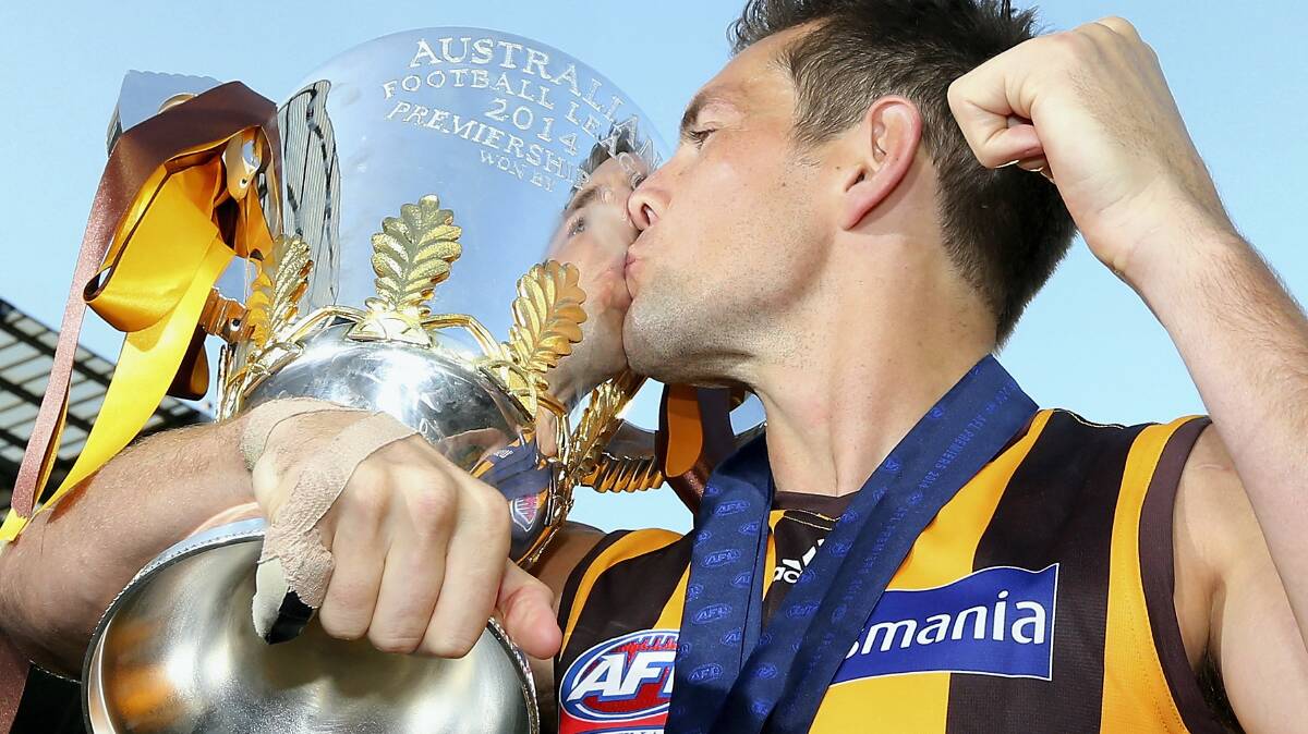 Hawthorn captain Luke Hodge kissing the premiership cup ... the Hawks will celebrate with their Tassie fans on Wednesday.Picture: GETTY IMAGES