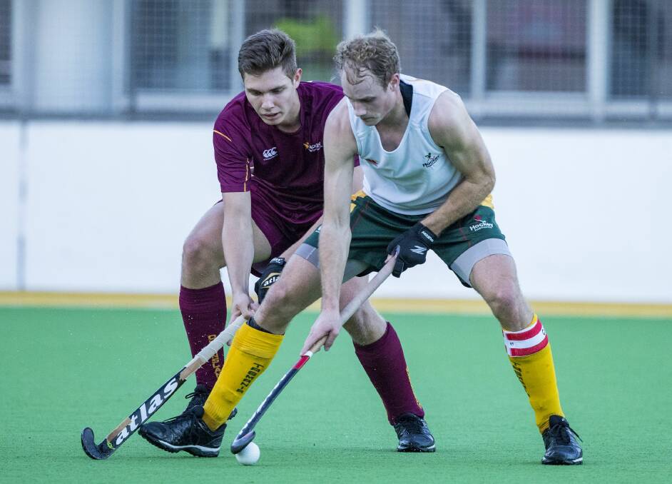 KEEP AWAY: Tasmanian captain Jack Welch shields the ball from the Queensland clutches during the state's opener at this year's Australian under-21 hockey championships in Sydney. Picture: Click In Focus