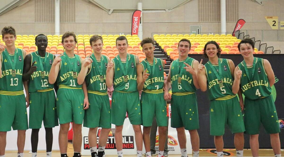 Match winner: Sejr Deans (No.6, third from right) 
celebrates victory with his Australian teammates.
Picture: Basketball Australia
