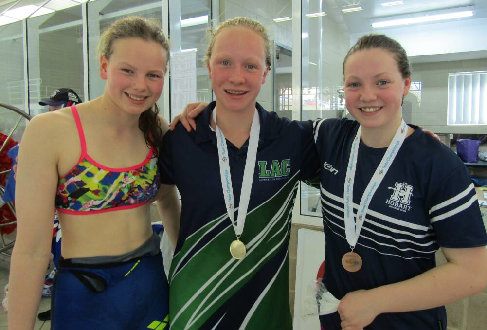 Podium pals: 100m butterfly medallists Sienna Palser, of HC, Amy Muldoon, of LAC, and Brenna Lemon, of Hobart.