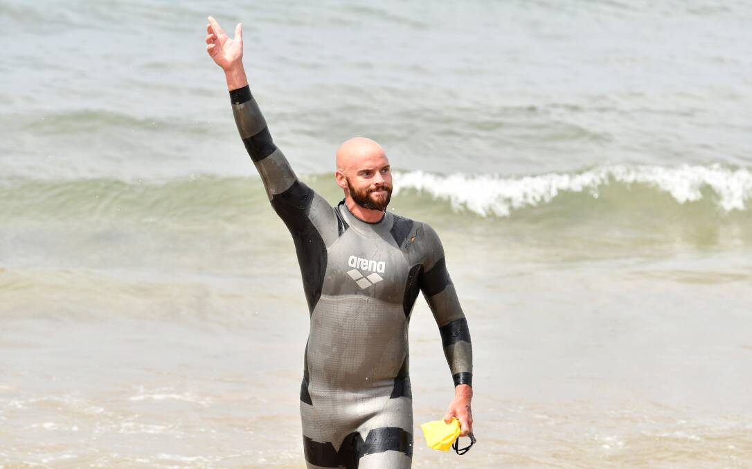 Crest of a wave: Hobart's Ray Winstanley comes out of the water at Devonport Surf Lifesaving Club to claim the pub to club line honours victory. Picture: Brodie Weeding.