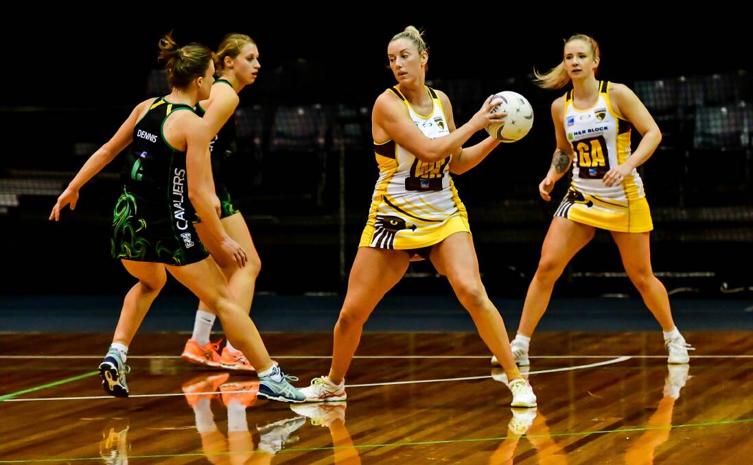 Path blocked: Cavaliers' Lucy Dennis confronts Hawks captain Danni Pickett in their State Netball League derby at the Silverdome on Saturday. Picture: Scott Gelston