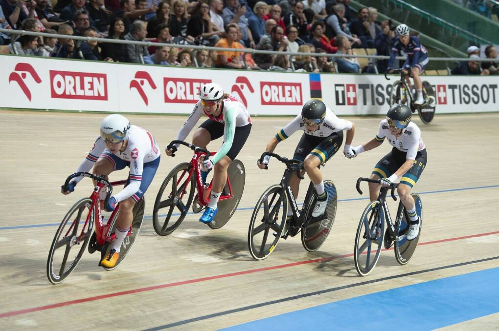 Hand up: Georgia Baker and Amy Cure on their way to winning silver in the madison at the 2019 world champs in Poland. Picture: Casey Gibson