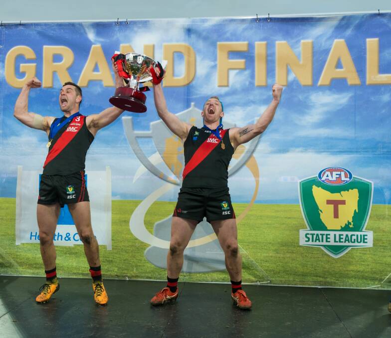 DREAM TEAM: Taylor Whitford and Brad Cox-Goodyer celebrating with the premiership cup has become a familiar image in the Tasmanian State League.