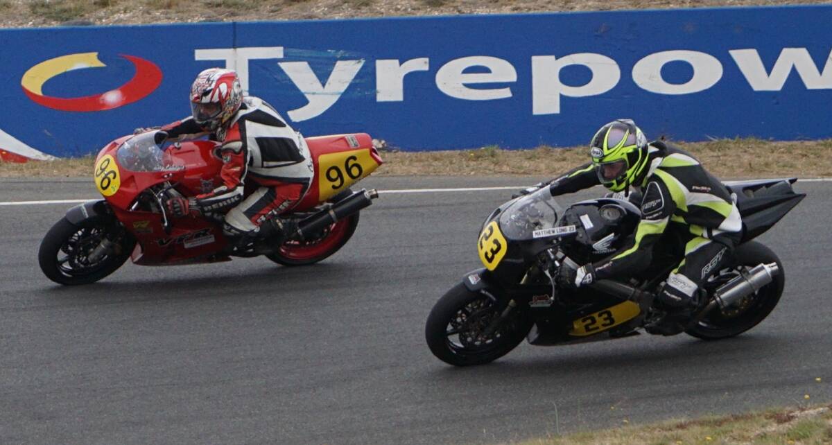 Craig Johnston, of Scottsdale, outbreaks Hobart’s Matthew Long into the hairpin at Symmons Plains on Sunday. Picture: Ken Young