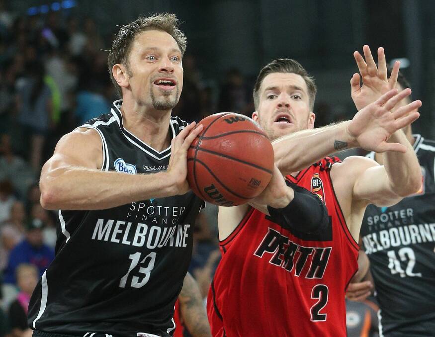 Cat call: Lucas Walker (right) playing for Perth Wildcats against David Andersen, of Melbourne United. Picture: AAP