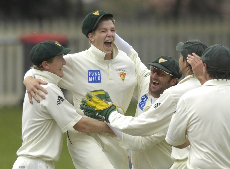 Paine barrier: George Bailey and Tim Paine celebrate a wicket with Tasmanian teammates in the victorious 2007 Sheffield Shield final.