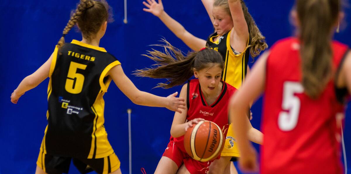 On the charge: Launceston Lightning's Sophie Dean attacks at the state basketball championships on Sunday. Picture: Phillip Biggs
