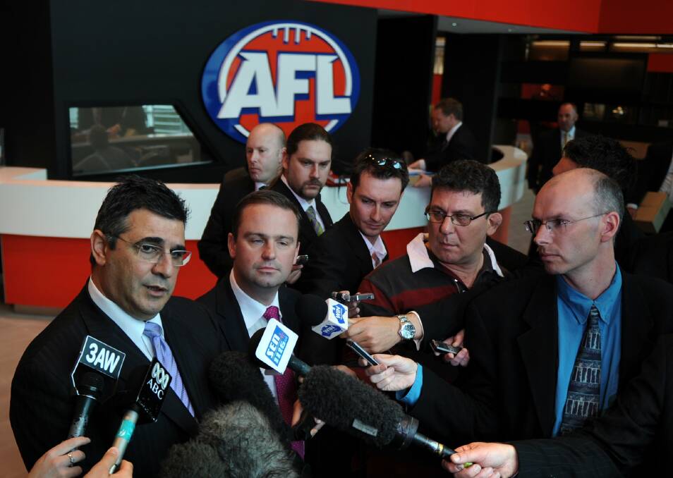 On the ball: Rob Shaw (right) in a media throng interviewing AFL chief executive Andrew Demetriou and Tasmanian Premier David Bartlett at AFL House in Melbourne in 2008.