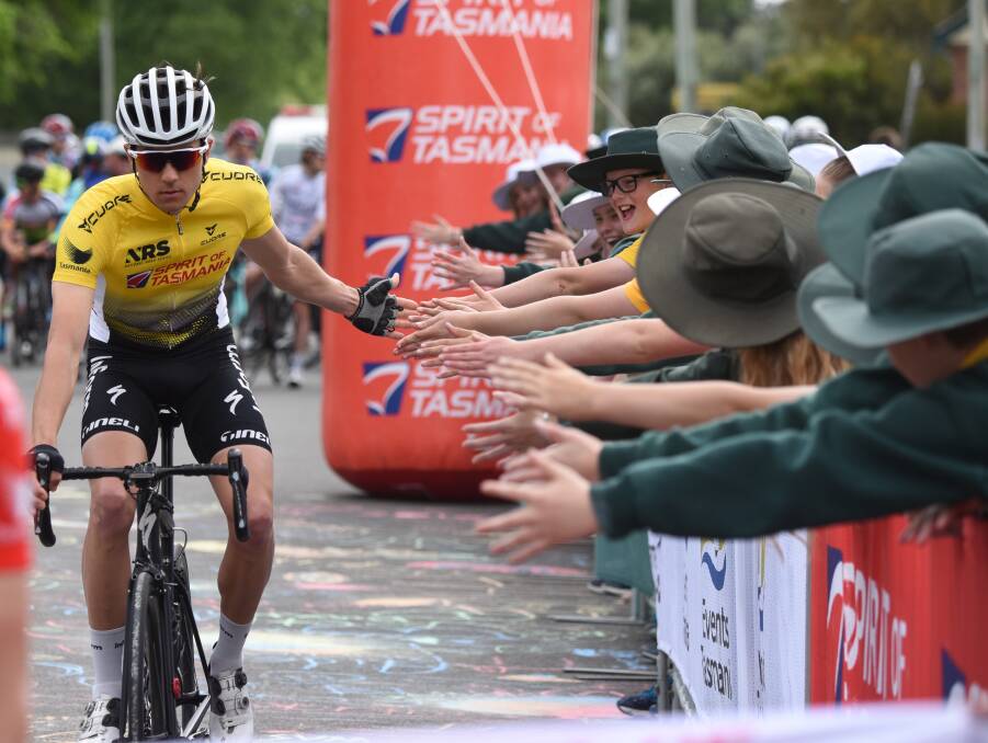 High hopes: Tour of Tasmania leader Raphael Freienstein high fives Longford Primary School pupils before Friday's stage. Picture: Paul Scambler