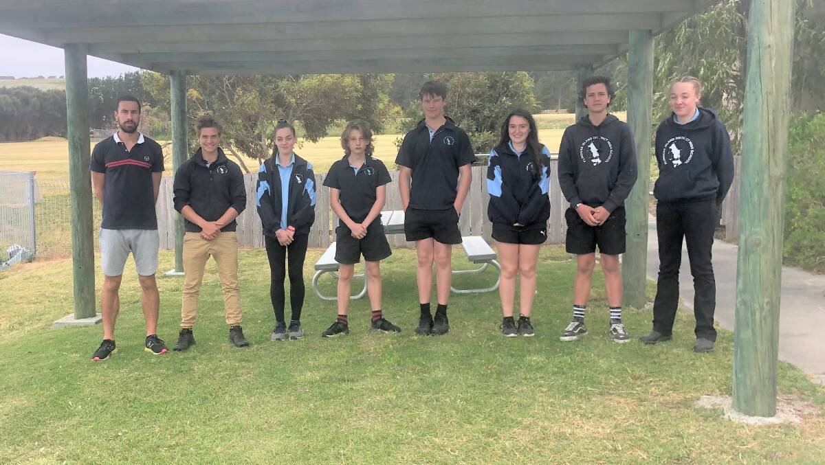 Teacher Justin Graham pictured with Flinders Island athletes Connor Wheatley, who has previously attended state athletics championships, Jodie Allott, Coopa Mathews, Archie Burke, Nina Hizzard, James Taylor-McKain and Sophie Allott, while May Wain will join them in Launceston.