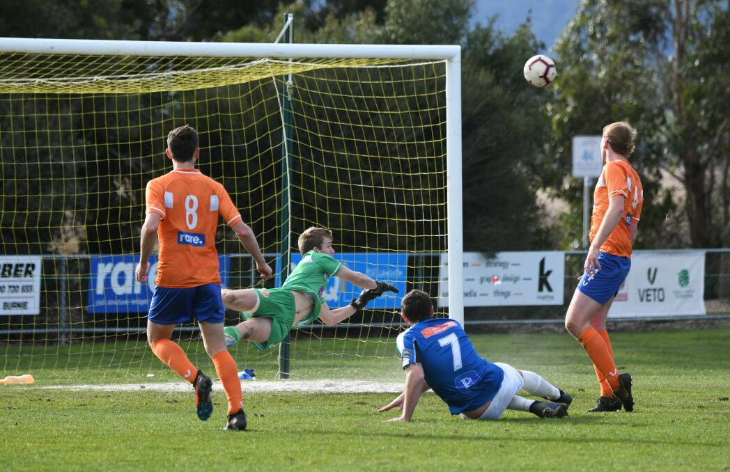 Hill climbing: Riverside goalkeeper Jarrod Hill pulls off a stunning save to deny Kingborough's Danny Cowen on Saturday. Picture: Paul Scambler