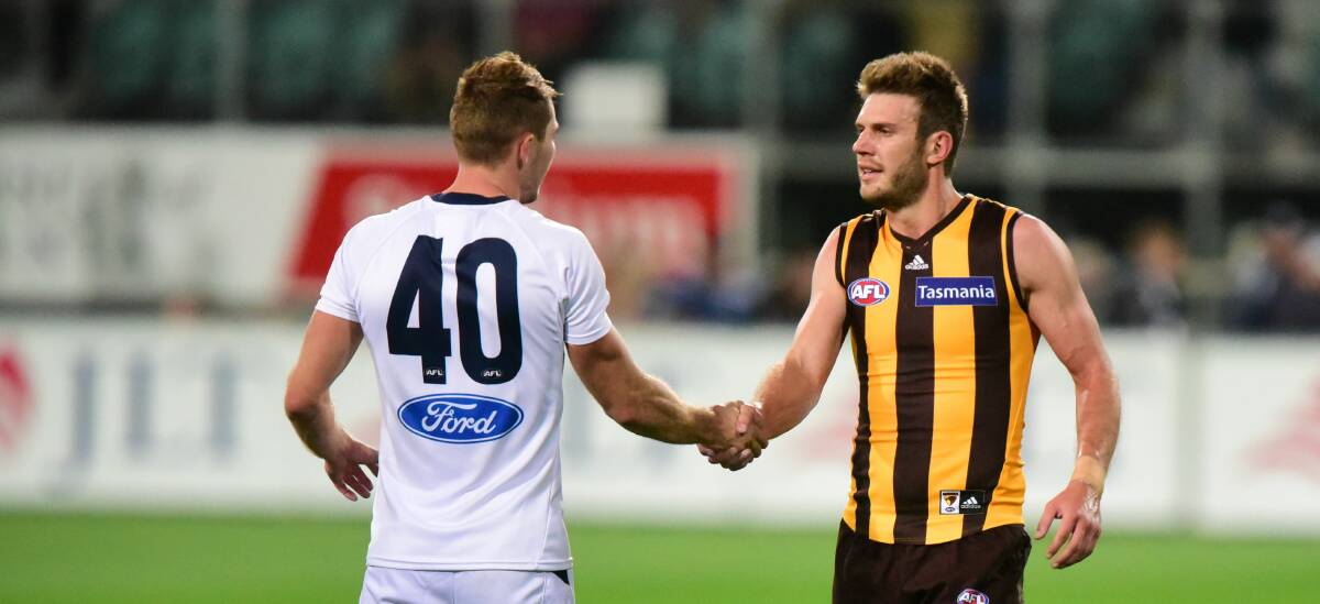 Shake up: Tasmanians Jackson Thurlow and Grant Birchall shake hands during the pre-season clash between Geelong and Hawthorn in Launceston. Picture: Paul Scambler