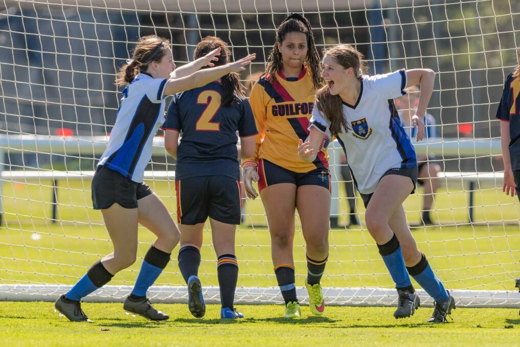 Double trouble: Launceston Church Grammar goal-scorers Bianca Anderson and Sarah Curtis celebrate during the SATIS final against Guilford Young. Picture: Phillip Biggs 