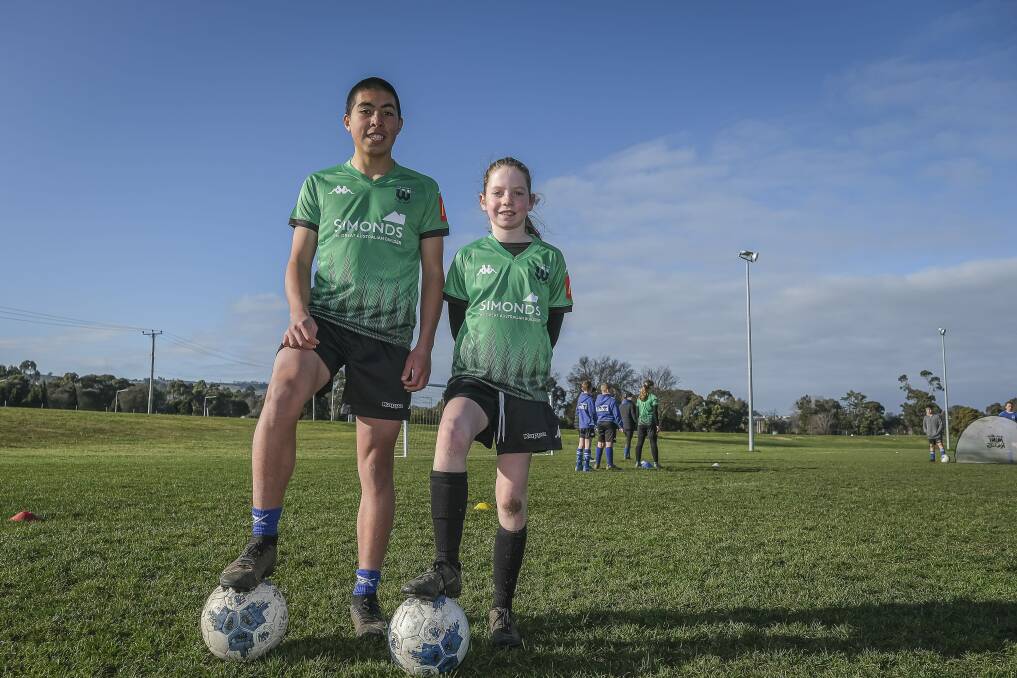 On the ball: Matias Munoz, 14, and Maisie Miller, 10, attending Western United's school holiday soccer camp at Birch Avenue, Launceston United. Picture: Craig George